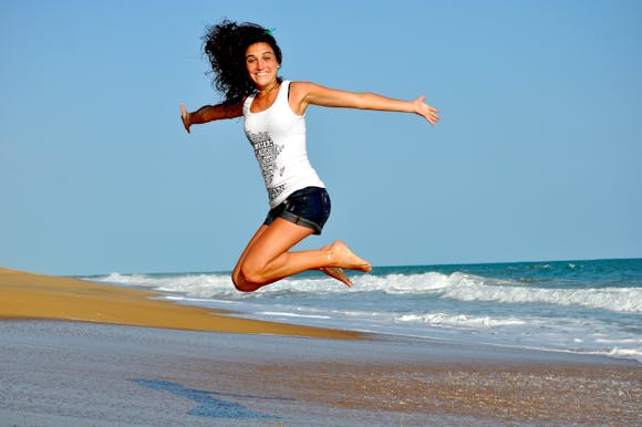 Person jumping on beach